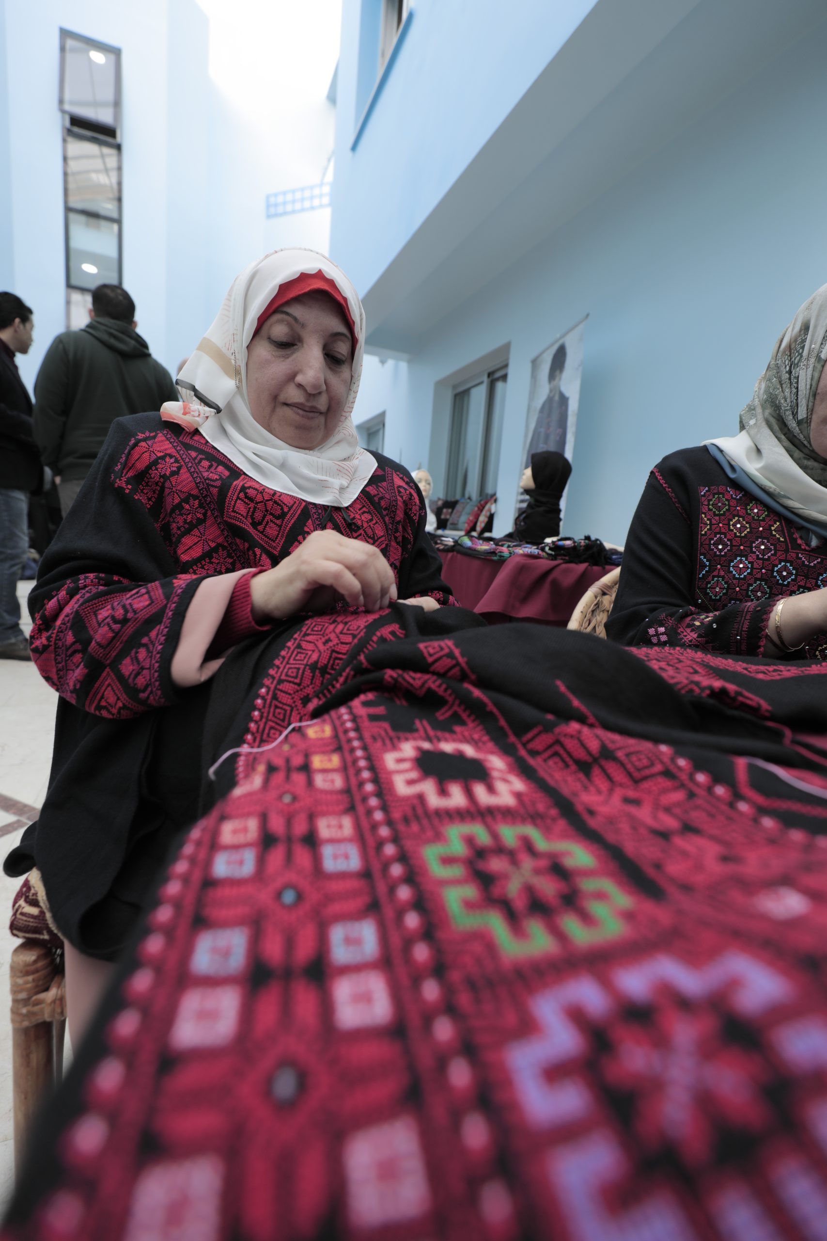 Palestinian woman while embroidering during Sulafa for embroidery launching event at UNRWA Gaza Headquarter. © 2022 UNRWA Photo by Mohamed Hinnawi.