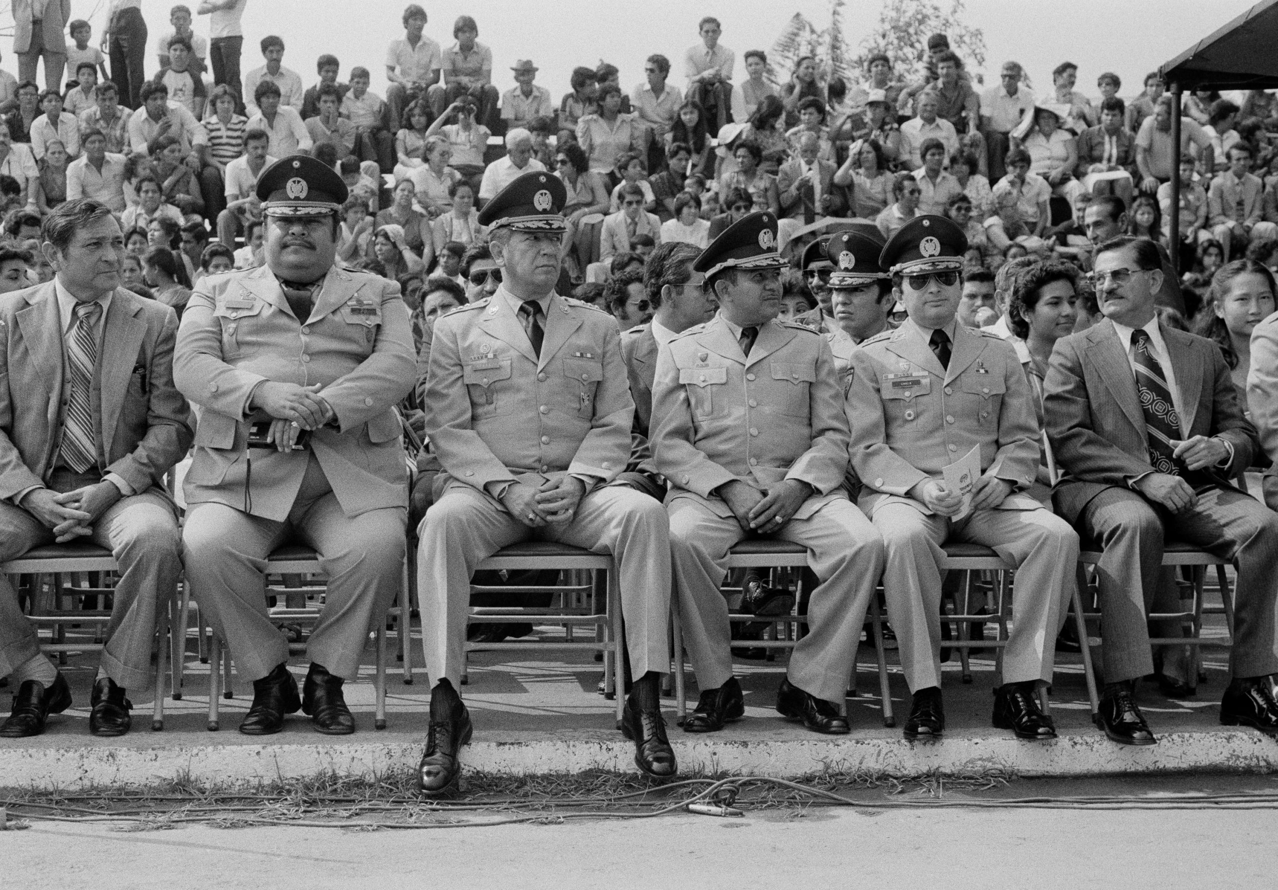 Salvadoran military commanders and the head of the Treasury Police Colonel Nicolás Carranza, 3rd left, sit during a military ceremony at the Escuela Militar Capitán General Gerardo Barrios in Santa Tecla, El Salvador, May 1983. (Photo by Robert Nickelsberg/Getty Images)